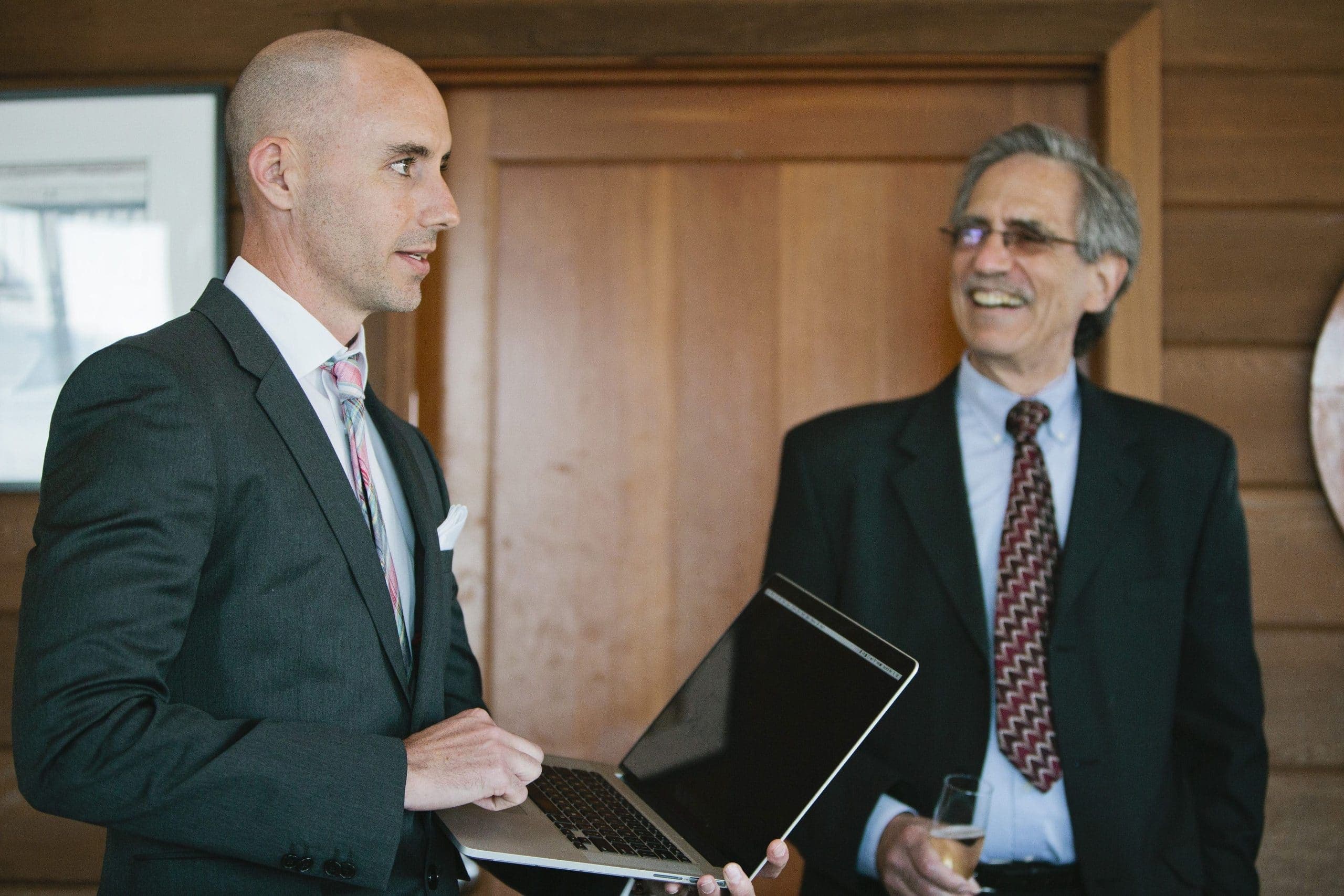 Sean Fargo in a suit, presenting with a laptop
