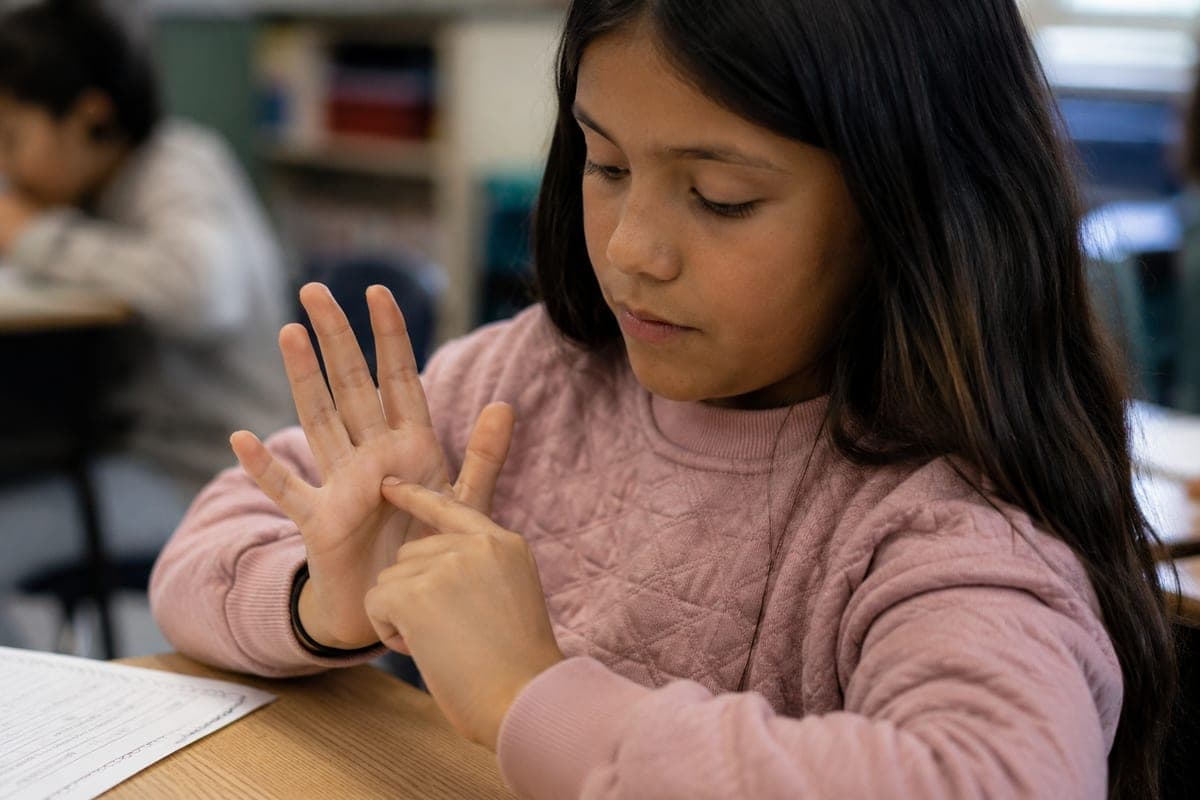Student practicing a hand tracing breathing exercise in the classroom