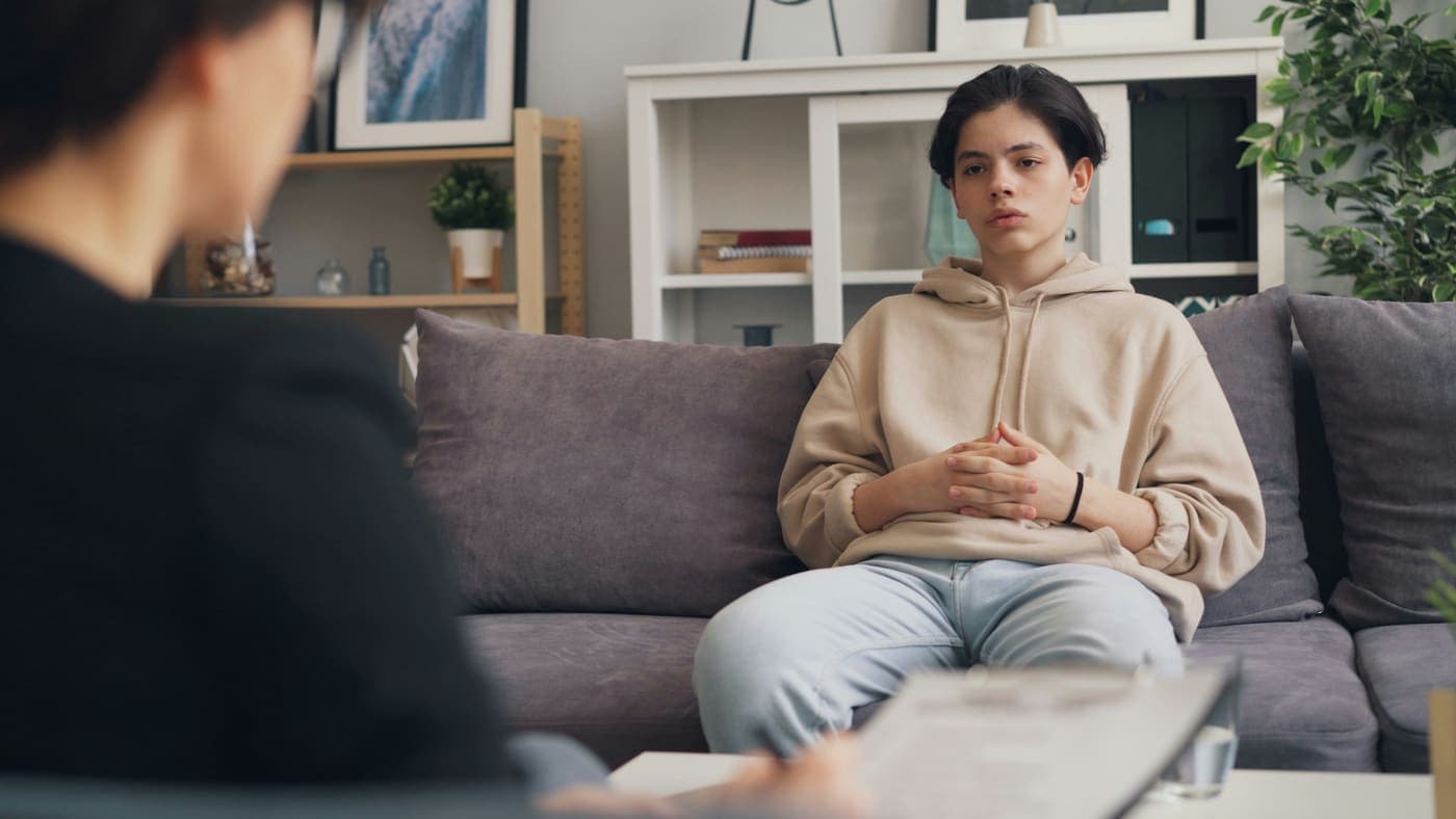A teenager talking one-on-one with a mindfulness teacher during a session